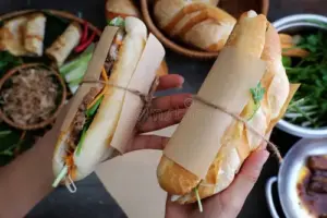 banh mi vietnamese bread woman hand make thit famous street food raw material pork ham pate egg fresh herbs as 93724331